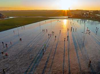 Aerial from ice skating at sunset on the ice rink in koudum friesland the netherlands