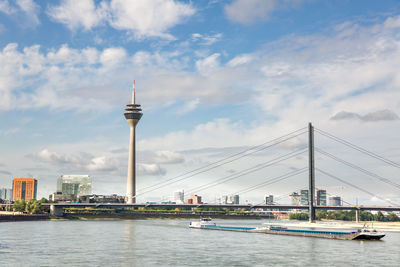 View of bridge over river against cloudy sky