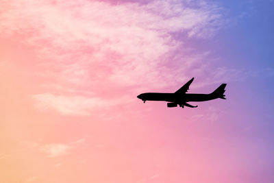 Low angle view of airplane flying in sky