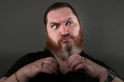 Portrait of man wearing mask against black background