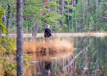 Rear view of man standing in lake