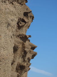 Low angle view of rock formation against sky