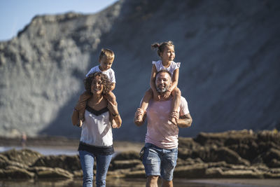 Full length of children with arms raised