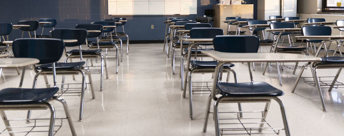 Empty chairs and tables in cafe