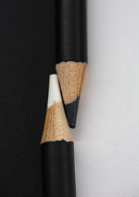 Close-up of pencils on table against white background