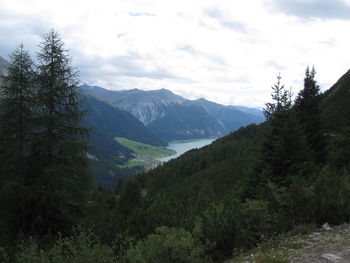 Scenic view of mountains against cloudy sky