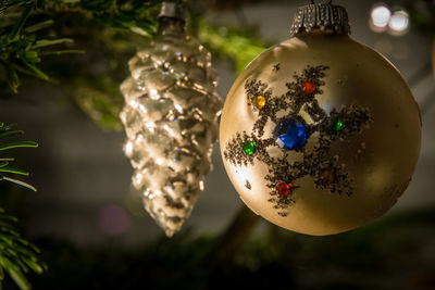 Close-up of ornaments hanging on christmas tree