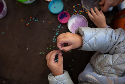 Cropped hand of woman blowing bubbles