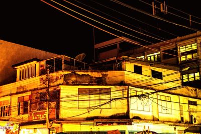 Illuminated railroad bridge in city at night