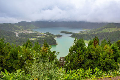 Scenic view of trees and mountains against sky