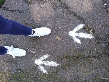 Low section of man standing on street