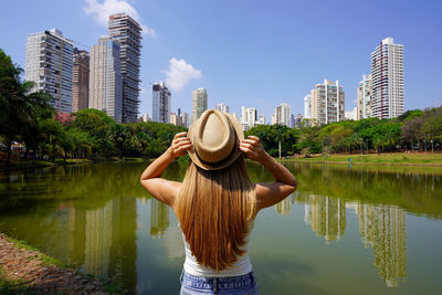 Tourism in goiania, brazil. rear view of girl in the city park vaca brava in goiania, goias, brazil.