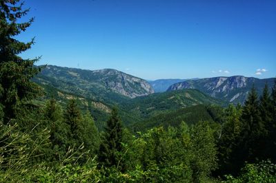 Scenic view of mountains against clear blue sky