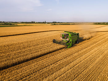 Combine harvester at agricultural field on sunny day