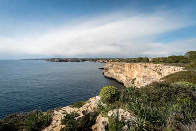 Scenic view of sea against cloudy sky