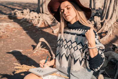 Full length of young woman standing outdoors