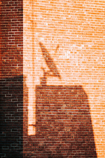 Shadow on red brick wall