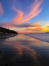 Scenic view of beach against sky during sunset