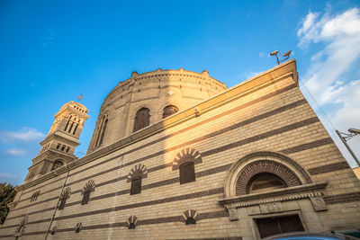 Low angle view of historical building against blue sky