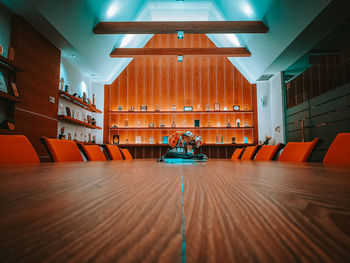 Empty chairs and tables in illuminated room