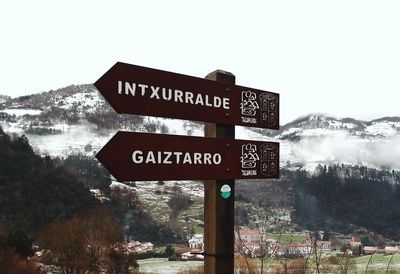 Close-up of road sign against clear sky