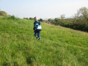 Rear view of boy on field