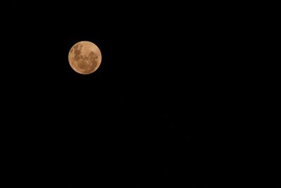 Low angle view of moon against sky at night