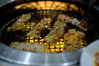 High angle view of meat on barbecue grill