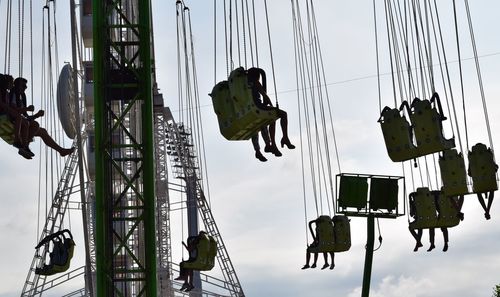 Low angle view of amusement park ride against sky