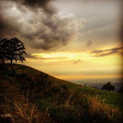 Scenic view of landscape against cloudy sky