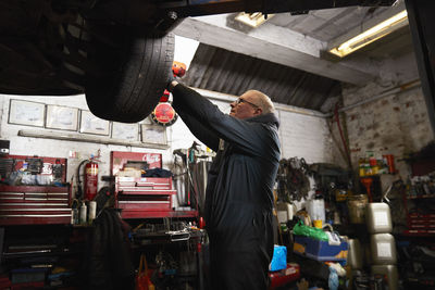 Male car mechanic working in garage