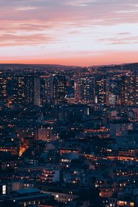 High angle view of illuminated buildings against sky at night