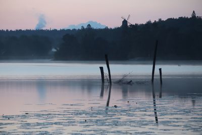 Scenic view of lake against sky during winter