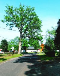 Empty road with buildings in background