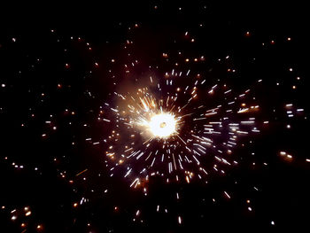 Low angle view of firework display at night