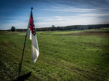 Scenic view of grassy field against sky