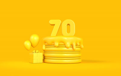 Close-up of yellow toy against orange background