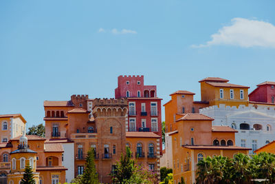 Low angle view of buildings against blue sky