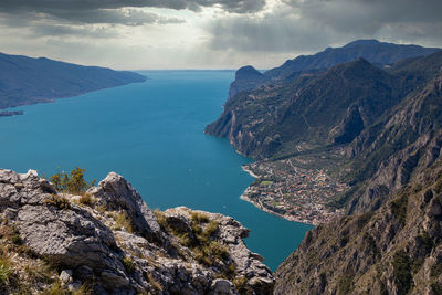 High angle view of sea and mountains against sky