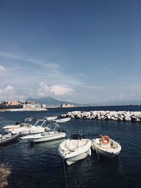 High angle view of sailboats moored on sea against sky