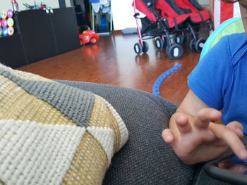 Close-up of person lying on sofa