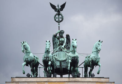 Low angle view of statue against sky