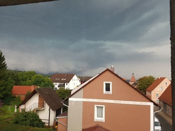 Houses in town against sky