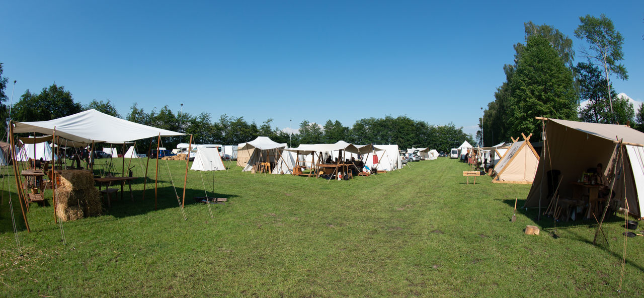 PANORAMIC VIEW OF HOUSES AND TREES AGAINST SKY