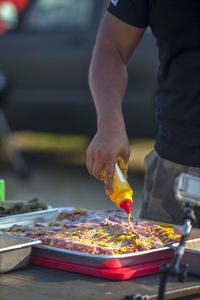 Chef putting sauce on beef