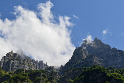 Low angle view of rocky mountains against sky