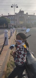 Rear view of boy on street in city