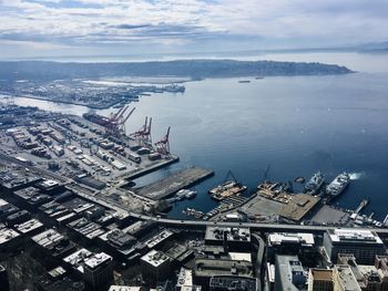 High angle view of buildings by sea against sky