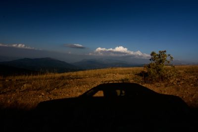 Scenic view of landscape against cloudy sky