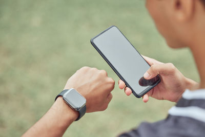 Midsection of man using mobile phone